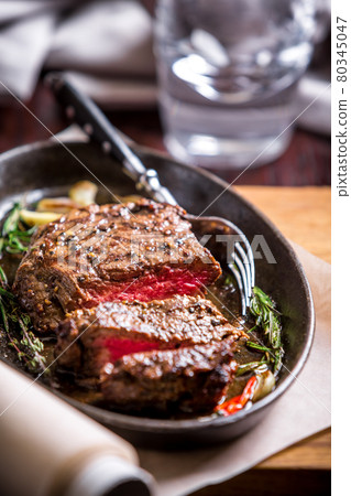 Healthy lean grilled medium-rare steak and vegetables 80345047