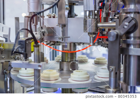 Automatic vacuum capping machine at package exhibition - demo mode Automatic vacuum capping machine at package exhibition - demo mode 80345353