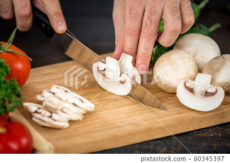 Male hands cutting vegetables for salad 80345397