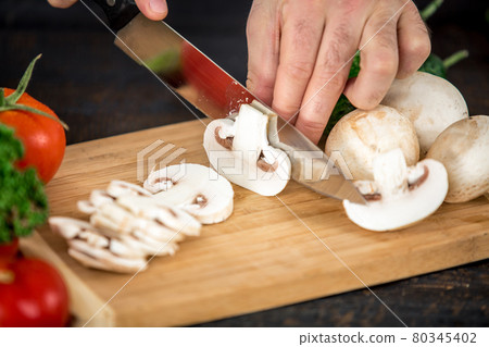 Male hands cutting vegetables for salad Male hands cutting vegetables for salad 80345402