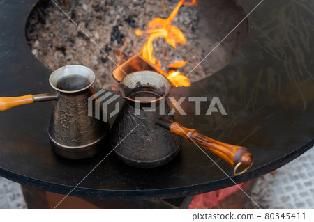 Preparing Turkish coffee with black cezve or ibrik at street food festival 80345411