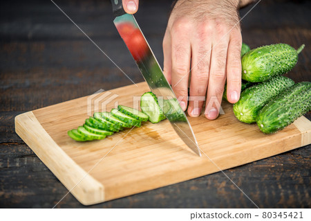Male hands cutting vegetables for salad 80345421