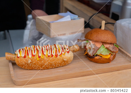Fresh burger and submarine hotdog sandwiche on counter - close up Fresh burger and submarine hotdog sandwiche on counter - close up 80345422