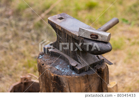 Hammer and blacksmith anvil at outdoor forge - close up Hammer and blacksmith anvil at outdoor forge - close up 80345433