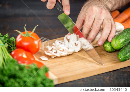 Male hands cutting vegetables for salad 80345440