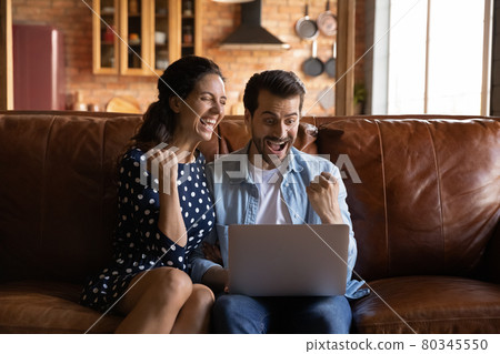 Overjoyed excited millennial couple getting good news Overjoyed excited millennial couple getting good news 80345550