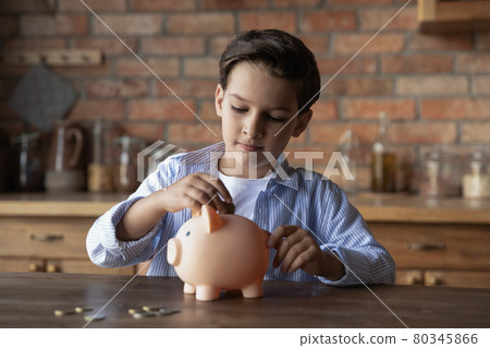 Focused school kid saving money for purchase Focused school kid saving money for purchase 80345866