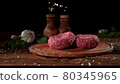 Super slowmotion footage of strewing salt and herbs at fresh raw beef meat burger, 1000fps, 4K 80345965