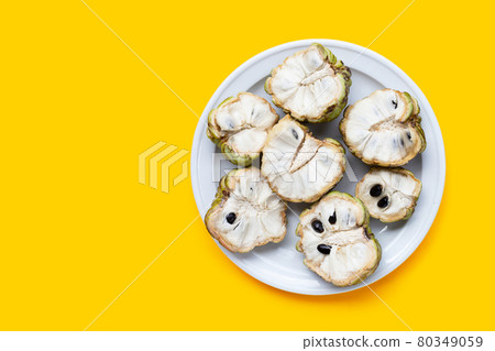 Custard apple in white plate on yellow background. Custard apple in white plate on yellow background. 80349059