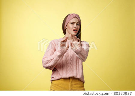 Omg no. Cute young european schoolgirl step back stooping grimacing disgusted and displeased turning away reluctant expressing aversion extending palm in rejection, refusal gesture over yellow wall 80353987