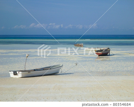 Multiple ships stranded on shallow beaches and white sands of Unguja, Tanzania Multiple ships stranded on shallow beaches and white sands of Unguja, Tanzania 80354684