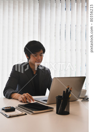 Successful businessman working in modern workplace. Successful businessman working in modern workplace. 80356215