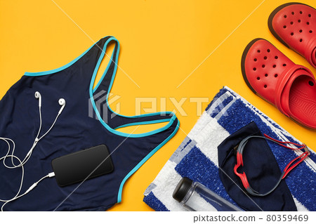 Flat lay summer pool accessories on a yellow background. Colorful beach wear. Flat lay summer pool accessories on a yellow background. Colorful beach wear. 80359469