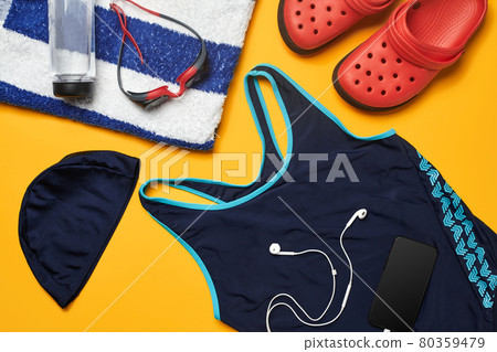 Flat lay summer pool accessories on a yellow background. Colorful beach wear. Flat lay summer pool accessories on a yellow background. Colorful beach wear. 80359479