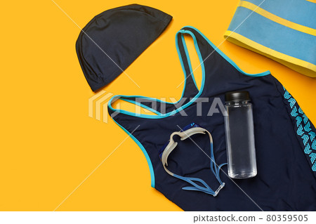 Flat lay summer pool accessories on a yellow background. Colorful beach wear. Flat lay summer pool accessories on a yellow background. Colorful beach wear. 80359505