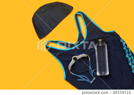 Flat lay summer pool accessories on a yellow background. Colorful beach wear. Flat lay summer pool accessories on a yellow background. Colorful beach wear. 80359518