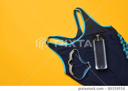 Flat lay summer pool accessories on a yellow background. Colorful beach wear. Flat lay summer pool accessories on a yellow background. Colorful beach wear. 80359558
