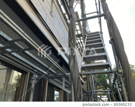 Scaffolding when painting the exterior walls of a house Scaffolding when painting the exterior walls of a house 80360233