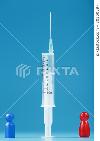 A miniature of a blue and red man between a syringe with a vaccine. 80360897