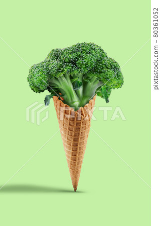 Raw broccoli in wafer cone over light green background. Healthy nutrition, food and seasonal vegetables harvest. Close up, copy space 80361052