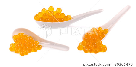 Yellow tapioca pearls for bubble tea isolated on white background. Tapioca pearls in ceramic spoon. Yellow tapioca pearls for bubble tea isolated on white background. Tapioca pearls in ceramic spoon. 80365476