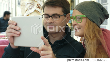 Young people having a video chat outdoor Young people having a video chat outdoor 80366329