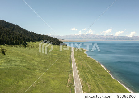 Lake and grassland with a sunny day. Shot in Sayram Lake in Xinjiang, China. Lake and grassland with a sunny day. Shot in Sayram Lake in Xinjiang, China. 80366806