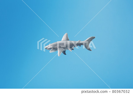 Shark toy on a blue background with free space. 80367032