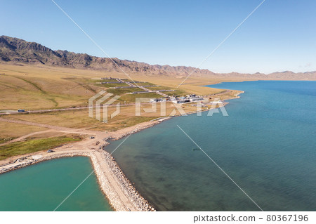 Lake and grassland with a sunny day. Shot in Sayram Lake in Xinjiang, China. Lake and grassland with a sunny day. Shot in Sayram Lake in Xinjiang, China. 80367196
