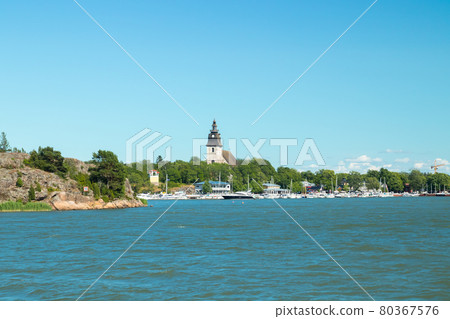 Naantali, Finland - 28 June , 2019: View from the sea of Naantali harbor and medieval stone church at sunny summer day, Finland Naantali, Finland - 28 June , 2019: View from the sea of Naantali harbor and medieval stone church at sunny summer day, Finland 80367576