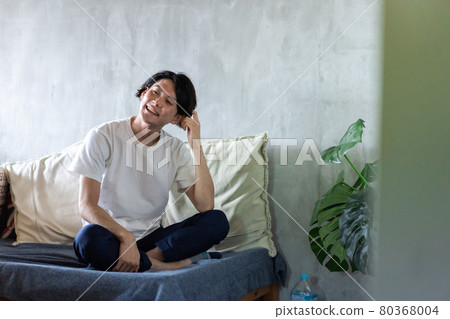 Young man stretching in bed Young man stretching in bed 80368004