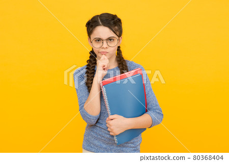 Homework develops study habits. Serious girl hold books. Homework develops study habits. Serious girl hold books. 80368404