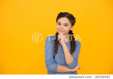 smiling kid girl with stylish braided hair on yellow background, beauty 80368405
