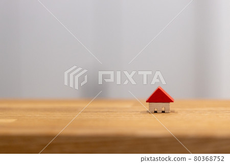 A small wooden house with a red roof on the kitchen counter A small wooden house with a red roof on the kitchen counter 80368752