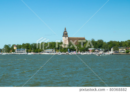 Naantali, Finland - 28 June, 2019: View from the sea of Naantali harbor and medieval stone church at sunny summer day, Finland 80368882