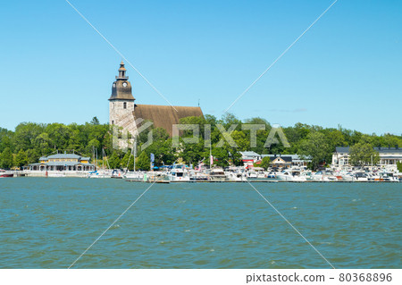 Naantali, Finland - 28 June, 2019: View from the sea of Naantali harbor and medieval stone church at sunny summer day, Finland 80368896