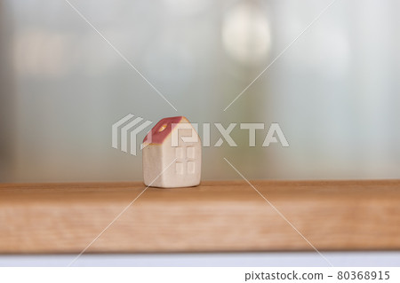 A small pottery house on the kitchen counter 80368915