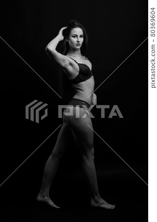 Slim tanned woman body over gray background 80369604