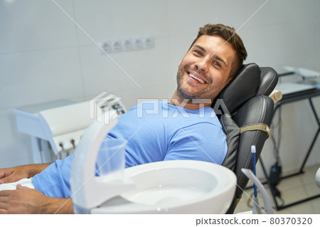 Cheerful gentleman smiling while waiting for dental appointment 80370320