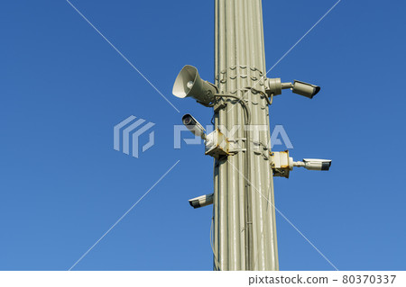 CCTV security cameras and outdoor loudspeaker on clear blue sky background CCTV security cameras and outdoor loudspeaker on clear blue sky background 80370337