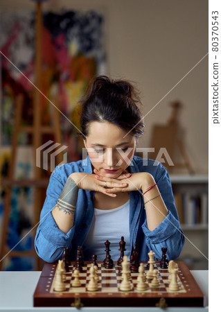 Young female concentrating hard of her next move at a chess game Stock  Photo - Alamy