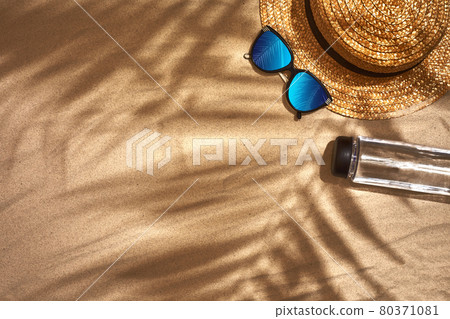 Women's beach accessories or summer outfit on sand background. Top view with copy space Women's beach accessories or summer outfit on sand background. Top view with copy space 80371081