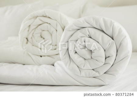 Duvet roll. down filled duvet rolled up isolated on white background Duvet roll. down filled duvet rolled up isolated on white background 80371284