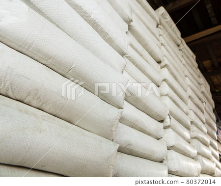 Pile of white plastic sacks in warehouse Pile of white plastic sacks in warehouse 80372014