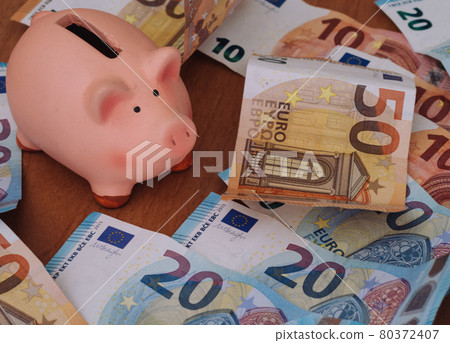 Piggy bank surrounded by European 50, 20 and 10 euro banknotes Piggy bank surrounded by European 50, 20 and 10 euro banknotes 80372407