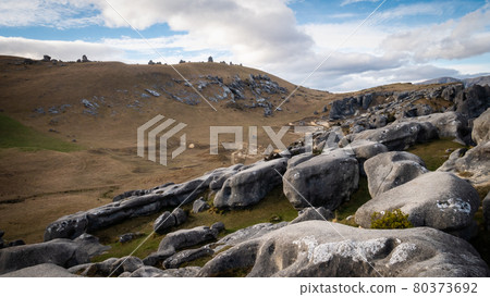Desert like landscape with rocks in foreground shot at beautiful location of Castle Hill, New Zealand Desert like landscape with rocks in foreground shot at beautiful location of Castle Hill, New Zealand 80373692