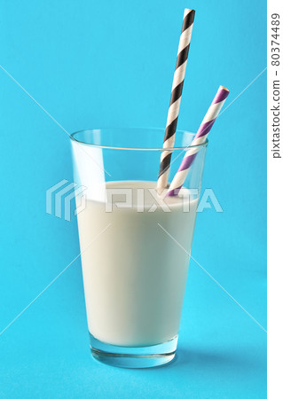 Glass of milk on the blue background. Glass of milk on the blue background. 80374489