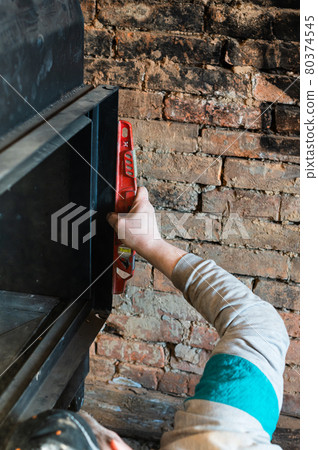 Installation of a large metal fireplace with a water circuit in the house, a profitable fireplace for heating. Installation of a large metal fireplace with a water circuit in the house, a profitable fireplace for heating. 80374545