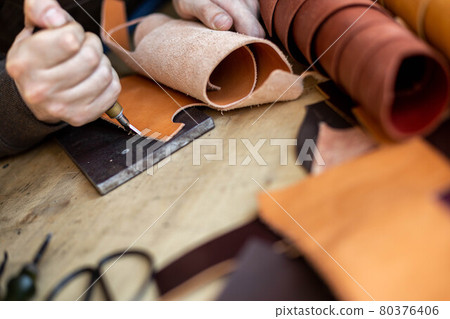 Craftsman machines edge of natural stuff workpiece use professional curly knife. Leather workshop Craftsman machines edge of natural stuff workpiece use professional curly knife. Leather workshop 80376406