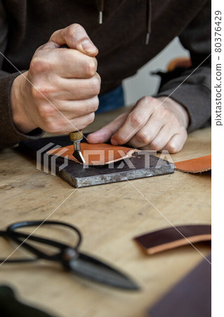 Craftsman machines edge of natural stuff workpiece use professional curly knife. Leather workshop Craftsman machines edge of natural stuff workpiece use professional curly knife. Leather workshop 80376429